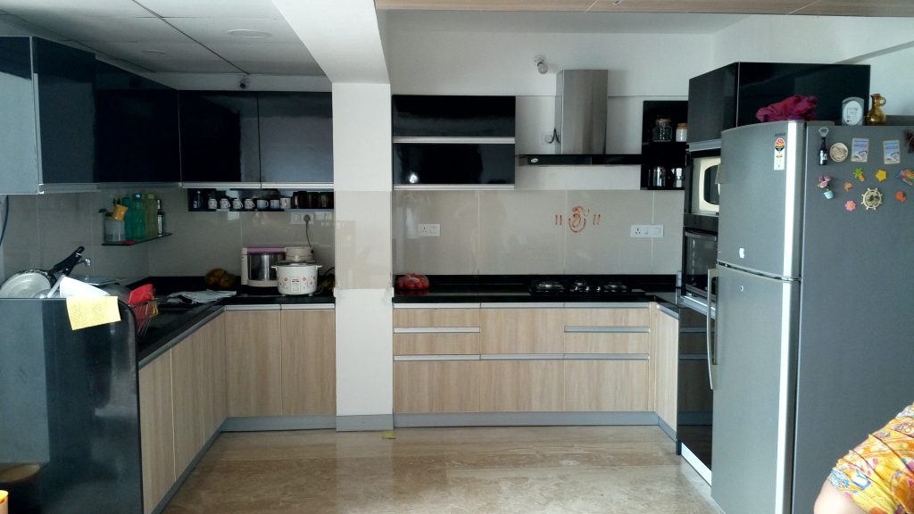 Modern open modular kitchen with sleek countertops and integrated appliances.