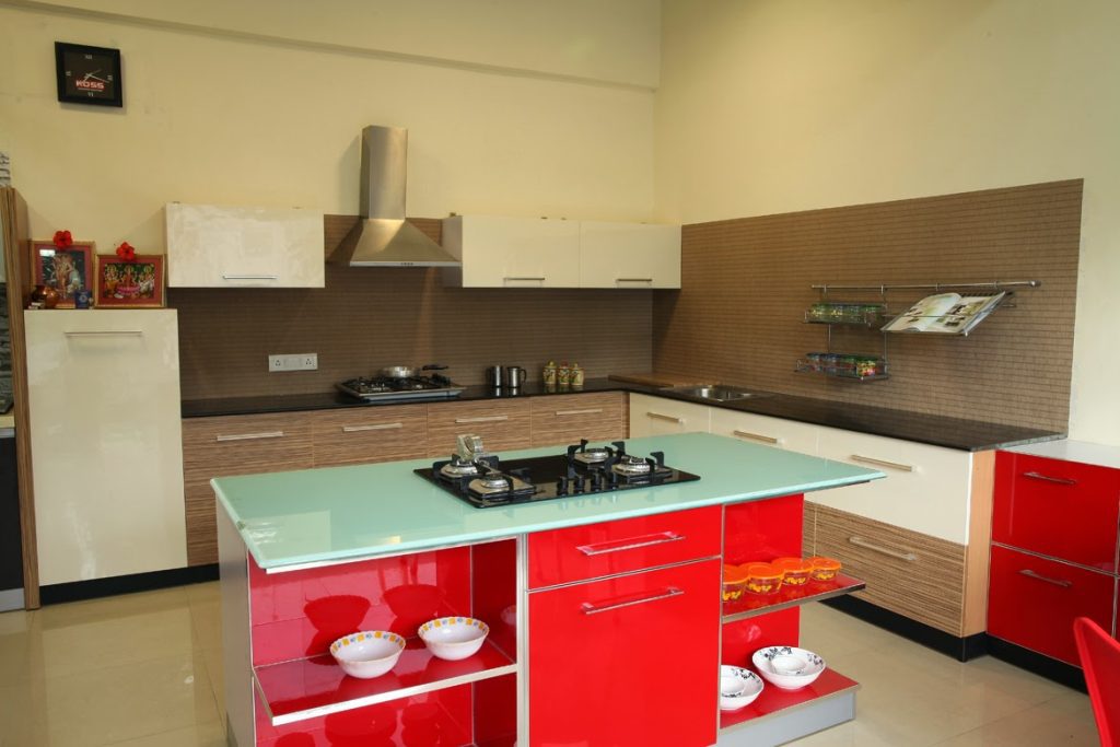 Bold red modular kitchen design with sleek cabinetry and modern fixtures.