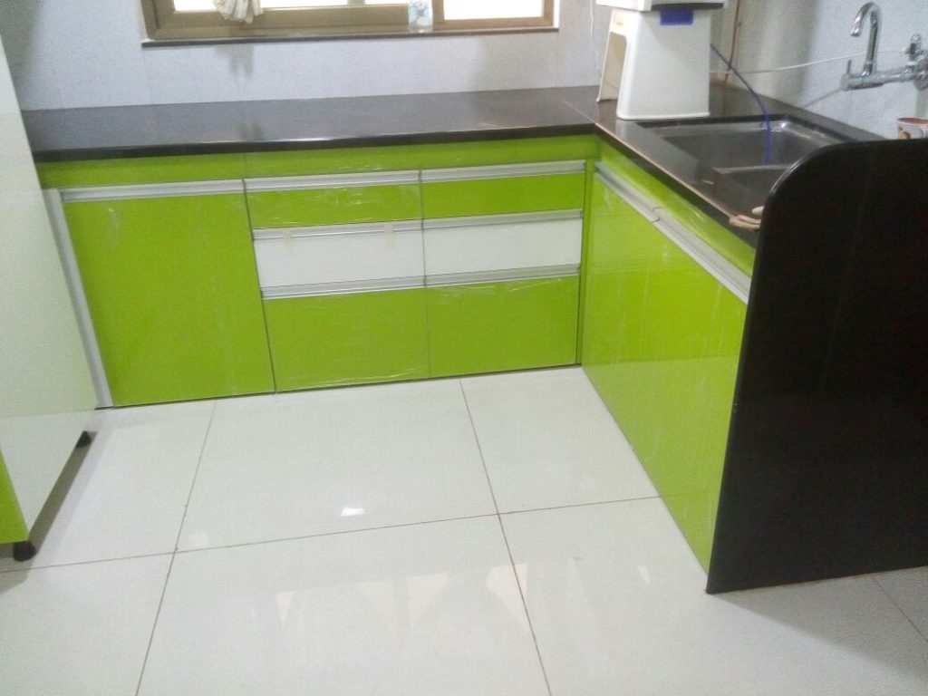 Stylish green acrylic kitchen featuring sleek cabinets and modern appliances, designed for a fresh and vibrant cooking space.