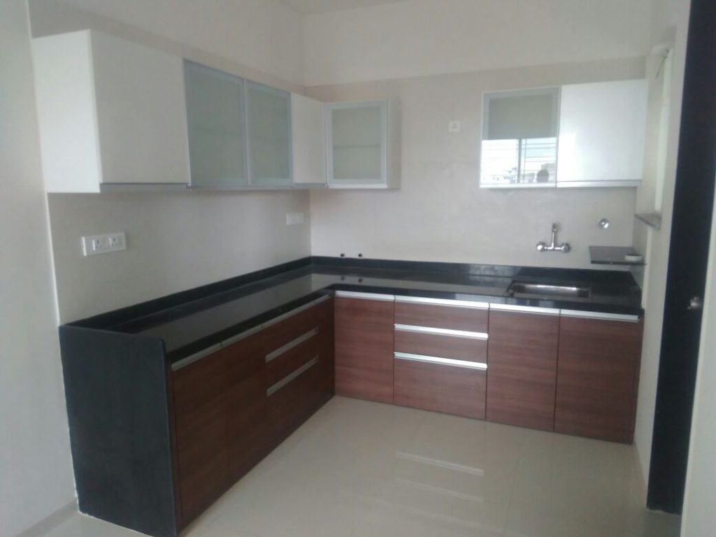 Modern L-shaped kitchen featuring stylish cabinetry and efficient layout.