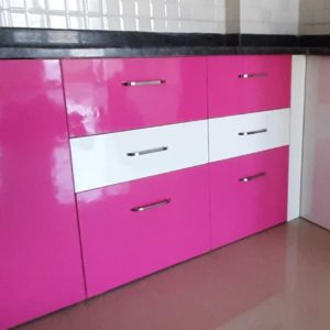 Modern pink modular kitchen with sleek cabinets and elegant finishes.