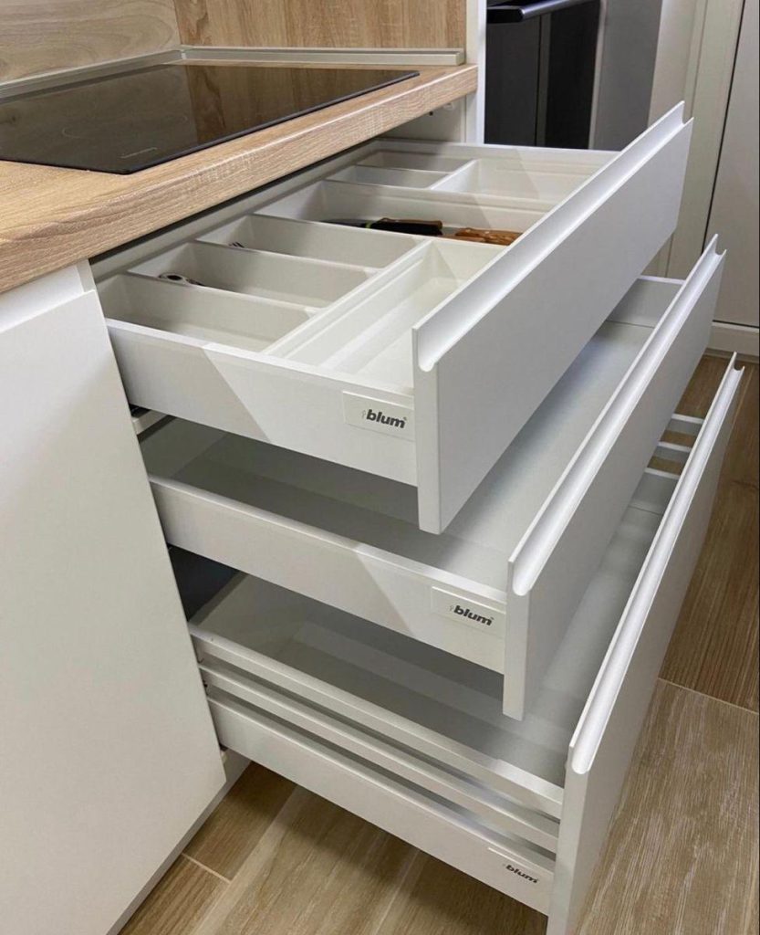 Tandem drawer storage inside acrylic modular kitchen