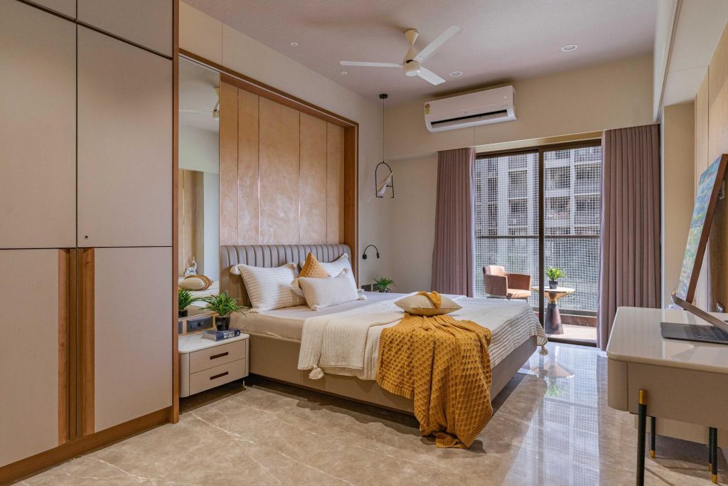 Modern bedroom interior with wooden wardrobe, bed and large windows