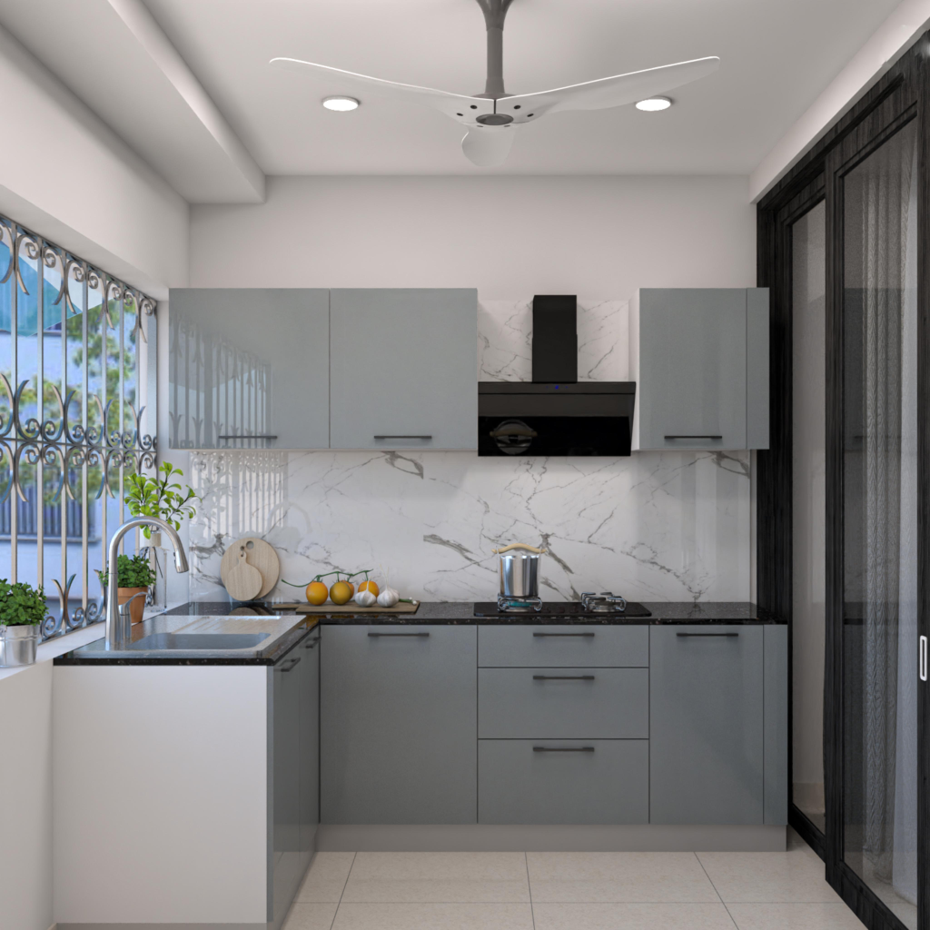 Modern gray kitchen with marble backsplash, black range hood, and ceiling fan; fruits and plants on the counter nearby.