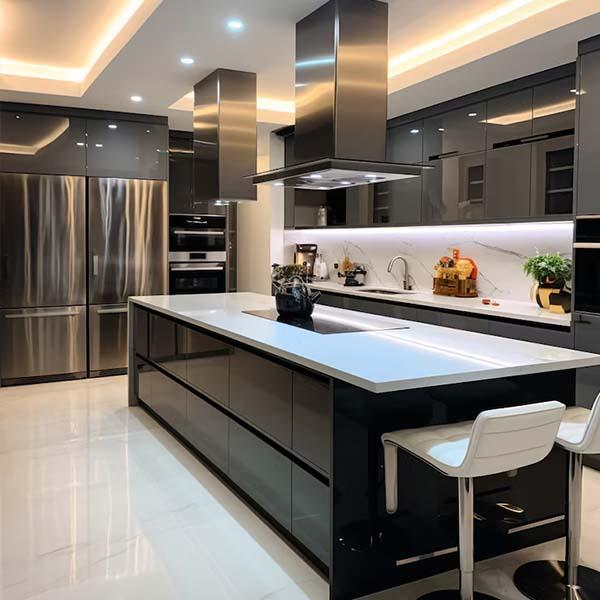 Modern black kitchen with a large central island, stainless steel appliances, and under-cabinet lighting.